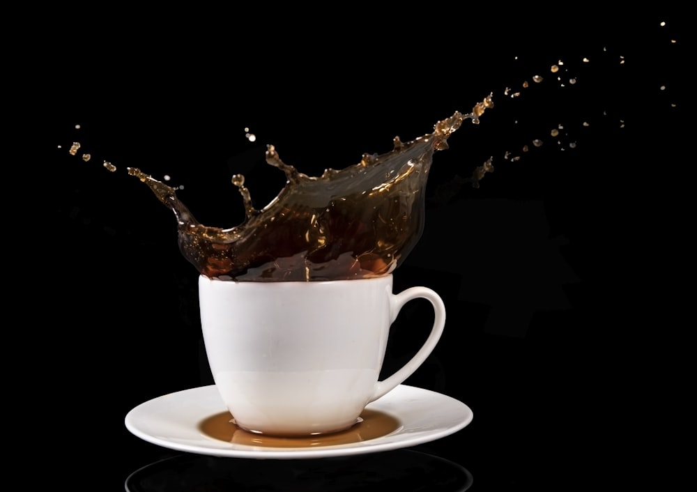 a cup of coffee with a splash of liquid