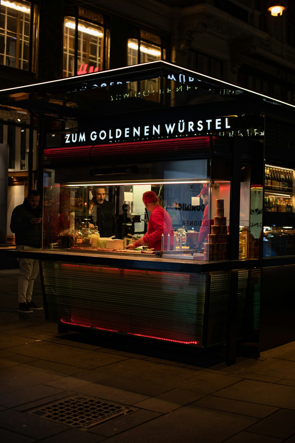 a food stand on a city street at night