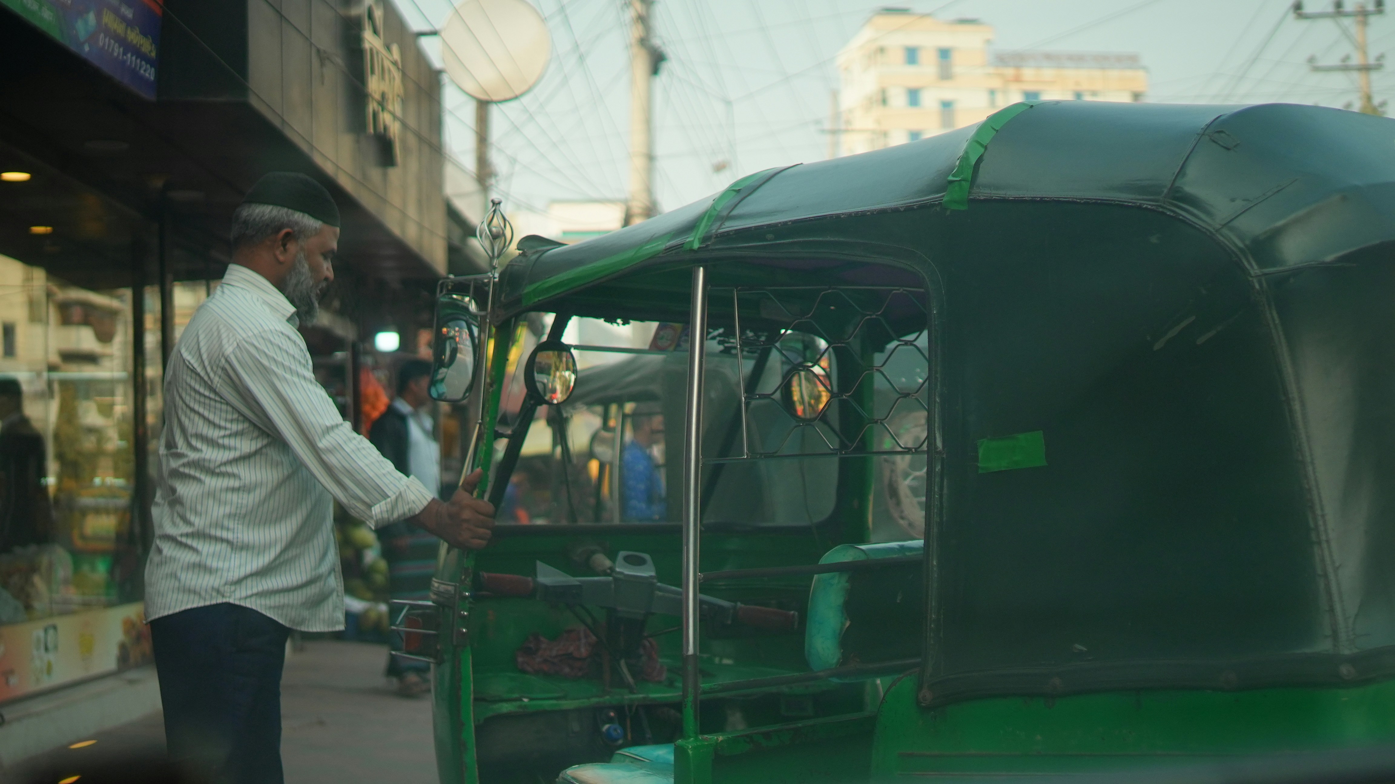 A man with a green vehicle