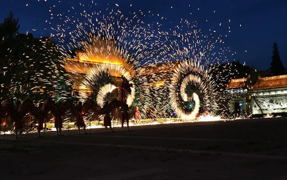 A vibrant night scene of a Pakistani wedding with glowing lanterns, golden stage lights, and colorful fireworks bursting in the sky.