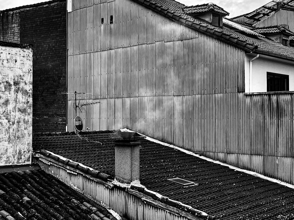 a black and white photo of rooftops and buildings