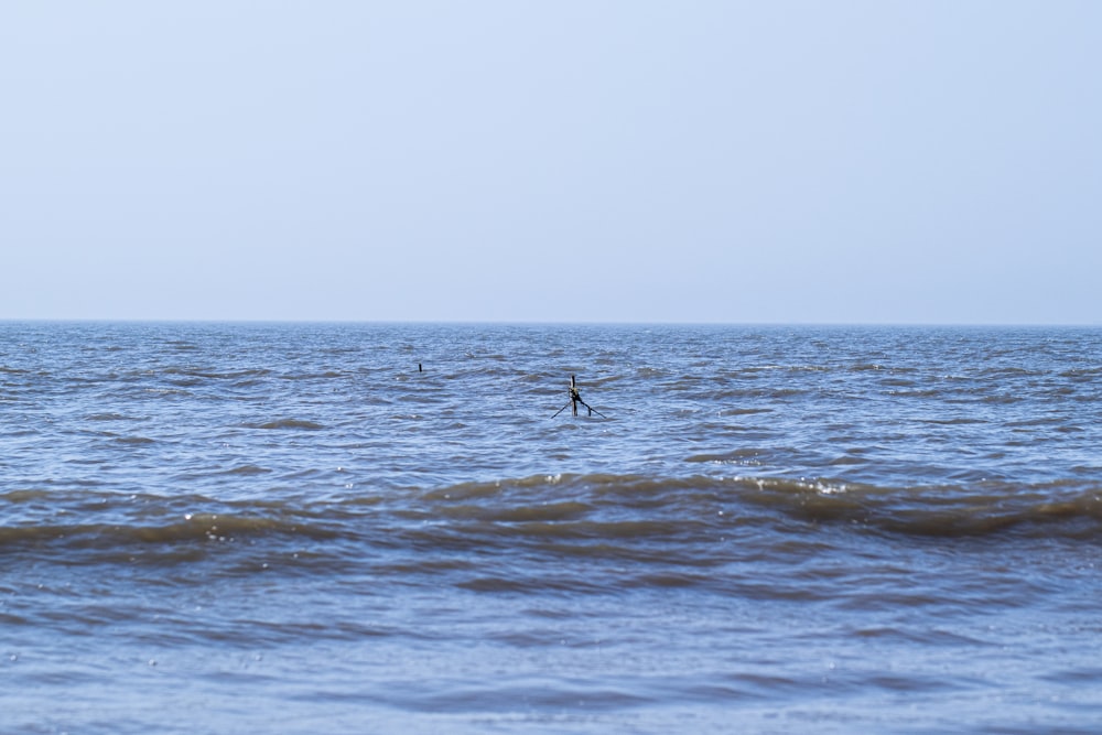 a person riding a surfboard in the middle of the ocean