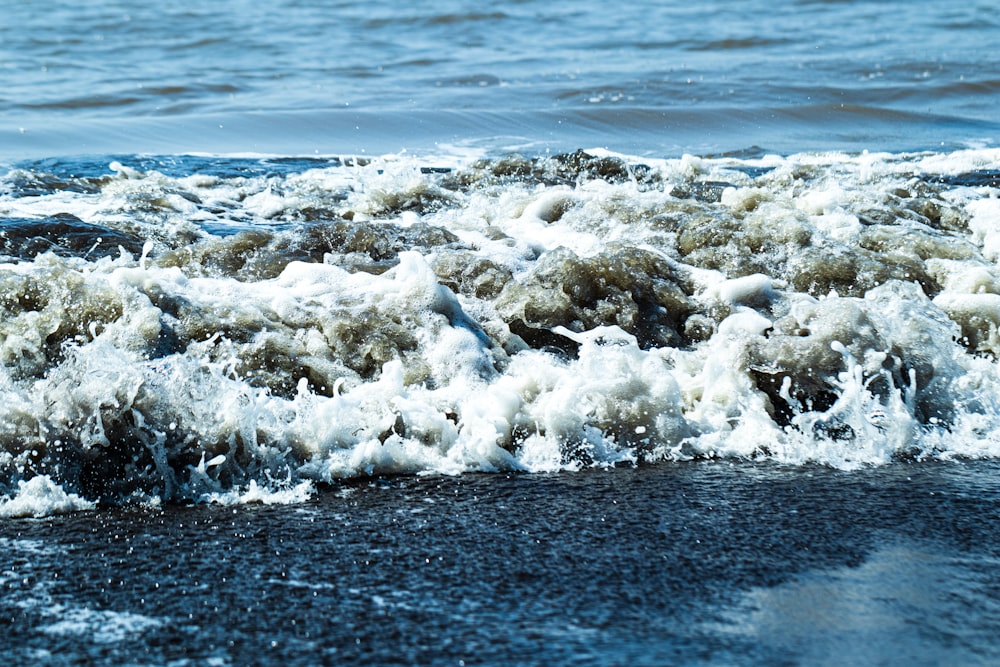 a close up of a wave on the beach