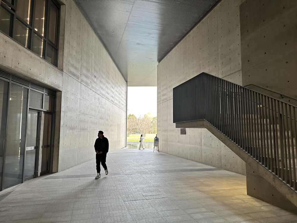 a person walking down a walkway in a building