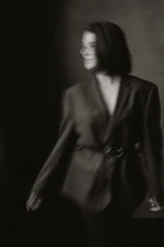 Moody black-and-white photo of a model wearing Rusbelsoon streetwear against an industrial backdrop.