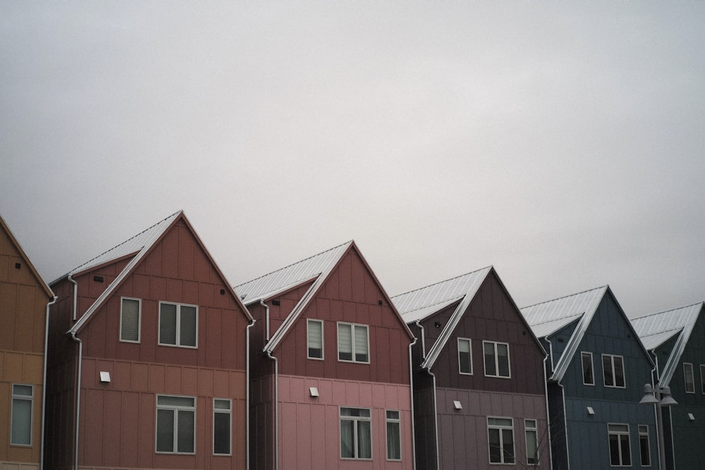 a row of multi - colored houses on a cloudy day