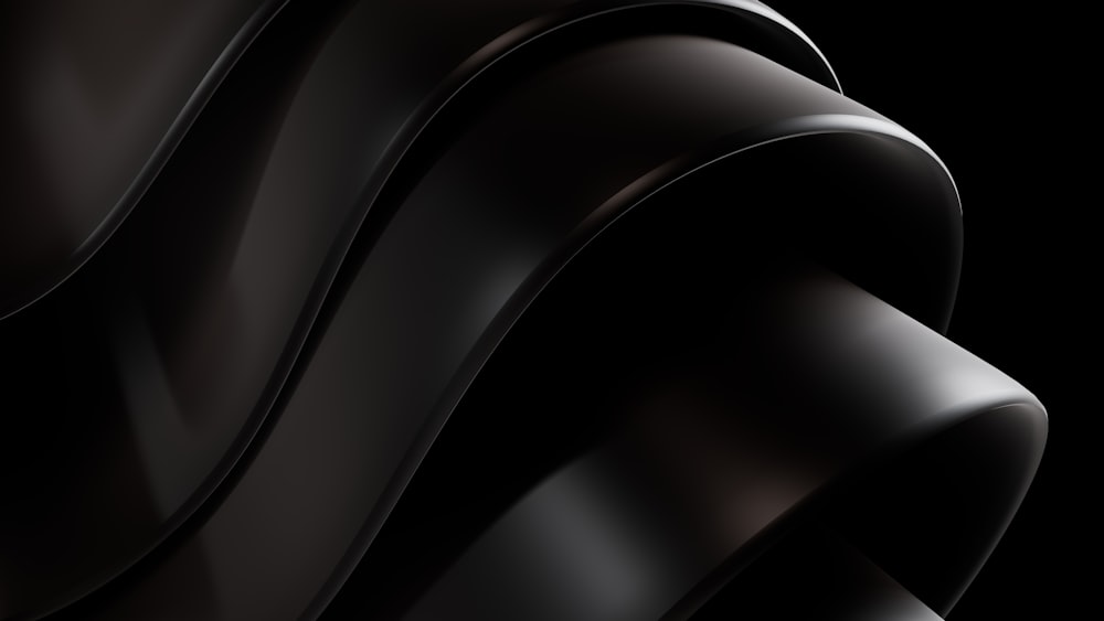 a close up of a black object with a black background