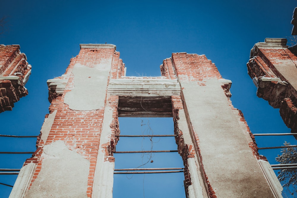 a tall brick building with a blue sky in the background