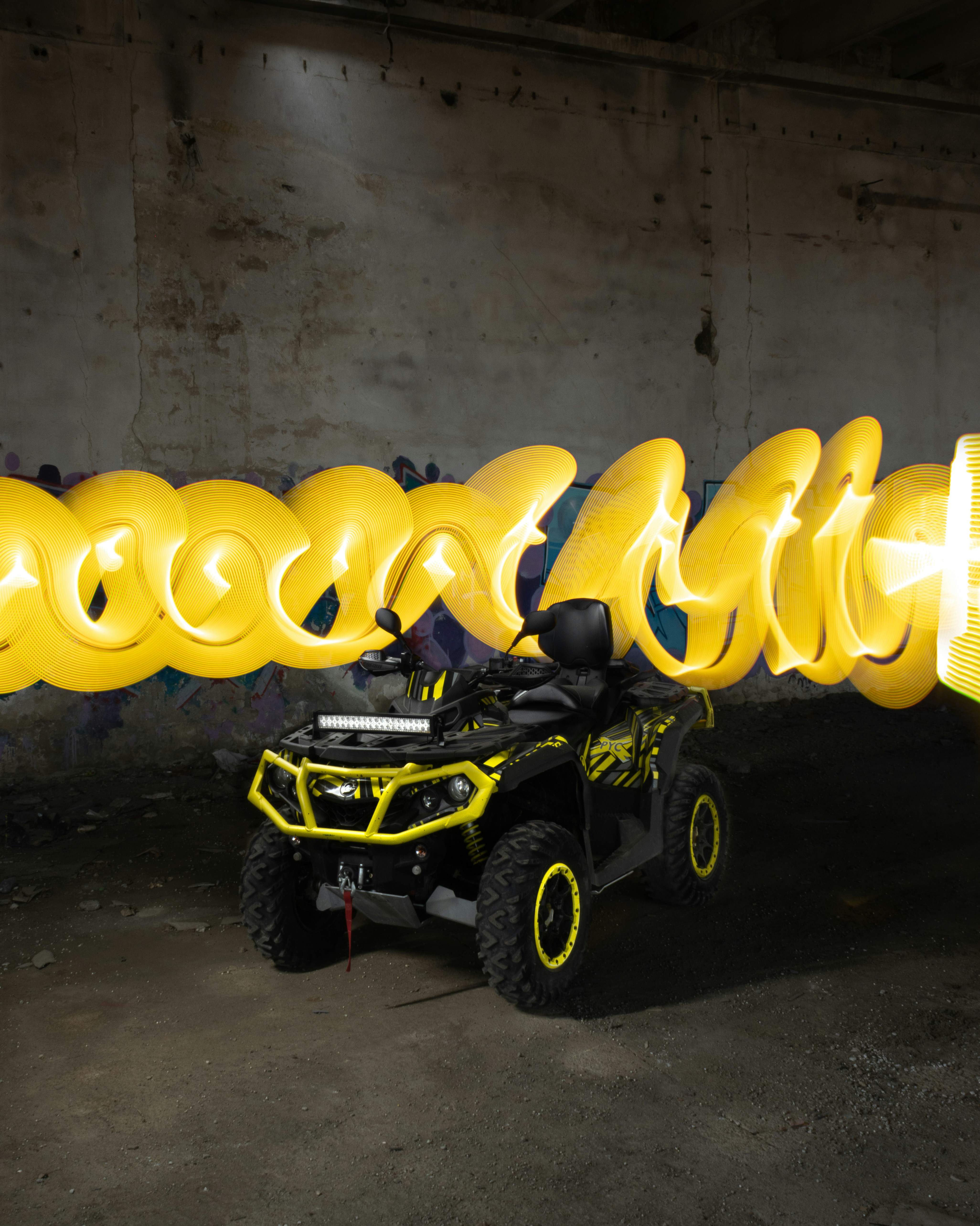 a can - am outlander parked in a parking garage