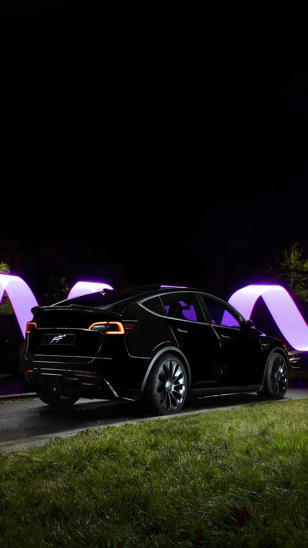 a black car parked on the side of the road