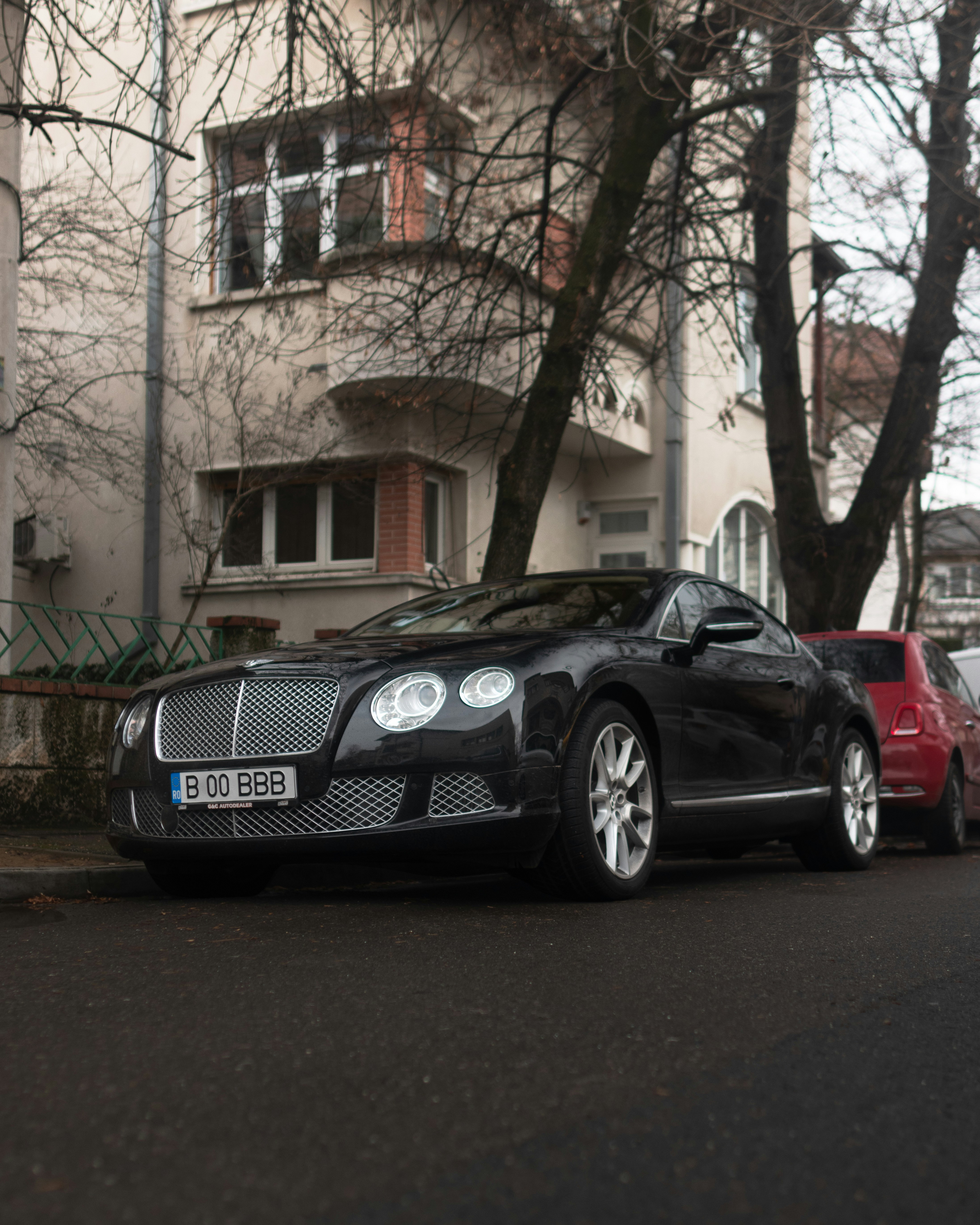 a black car parked on the side of the road