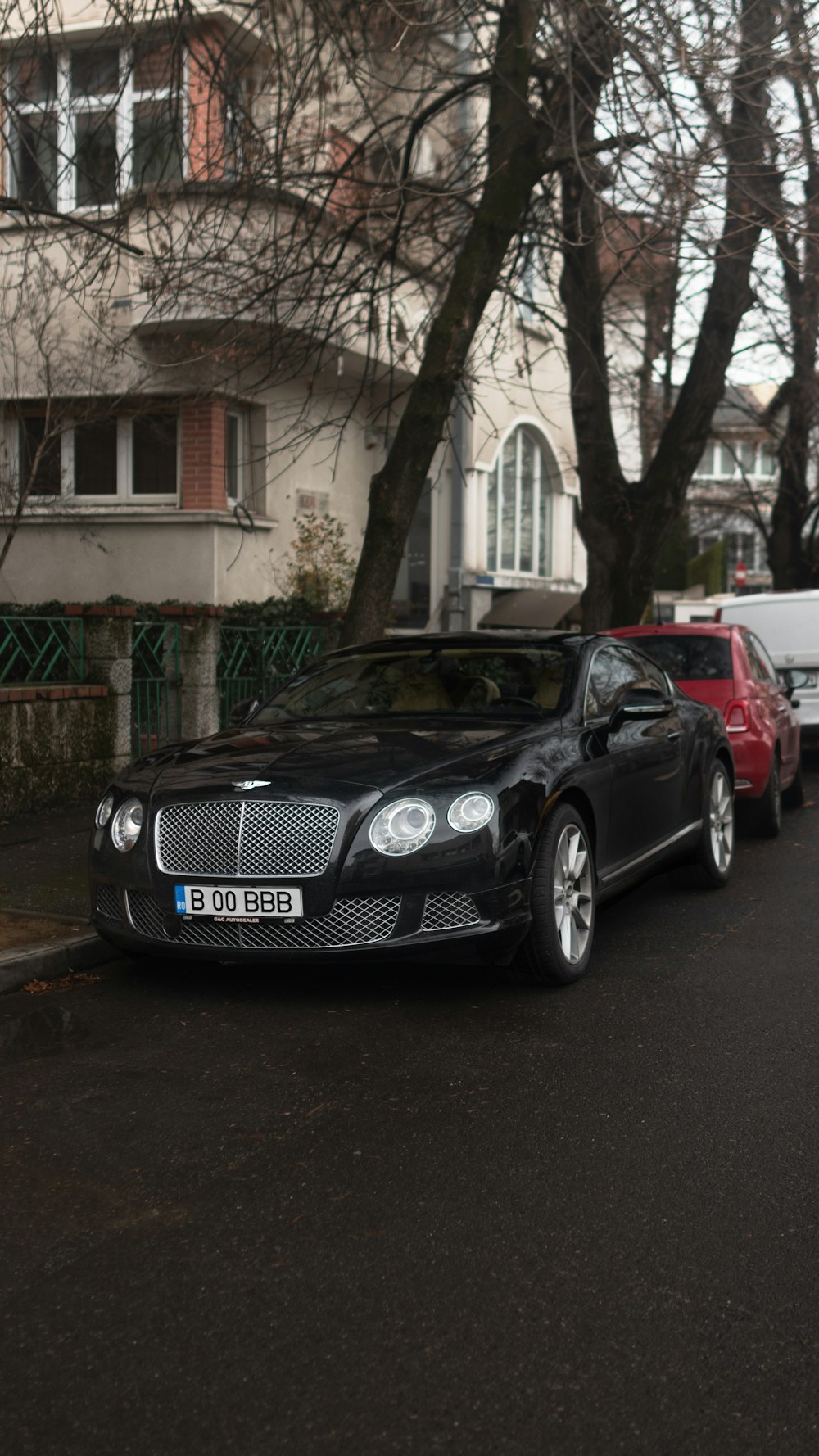 a black car parked on the side of the road