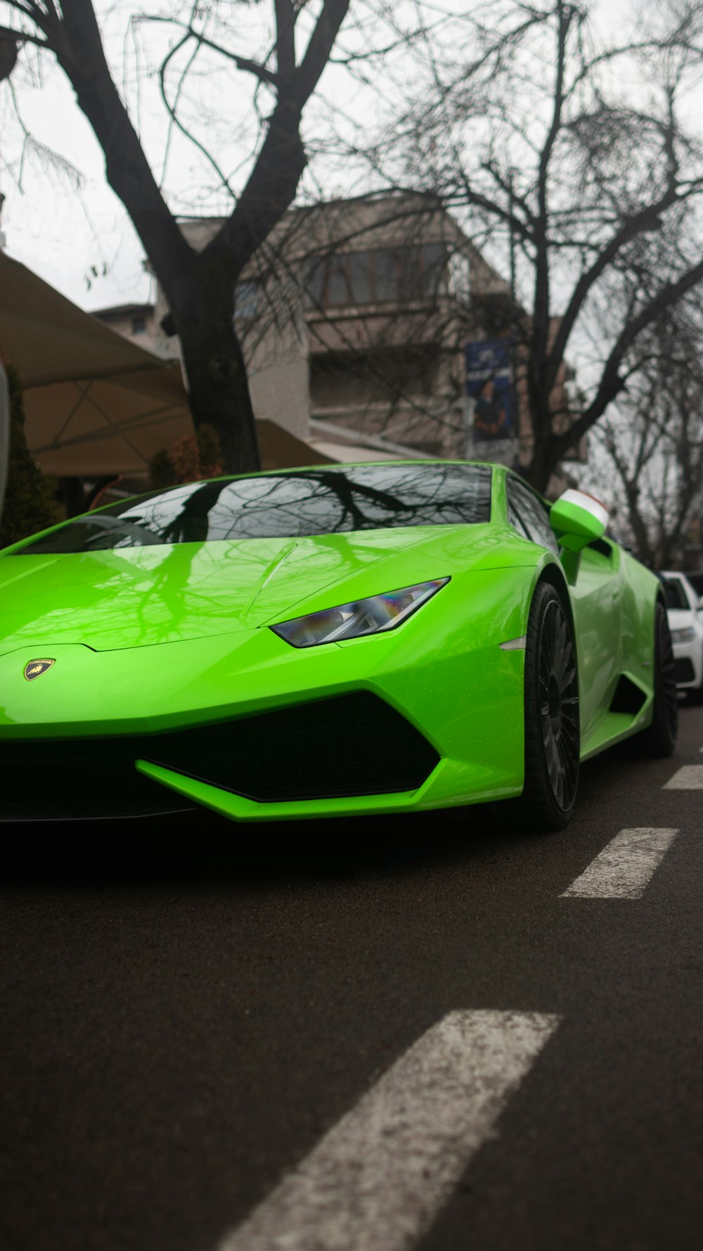 a green sports car parked on the side of the road