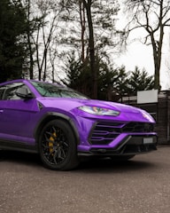 Luxury SUV parked outside the studio, showcasing a vibrant custom color wrap.