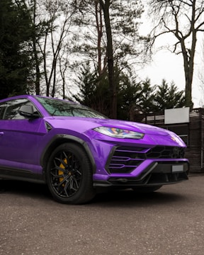 Luxury SUV parked outside the studio, showcasing a vibrant custom color wrap.