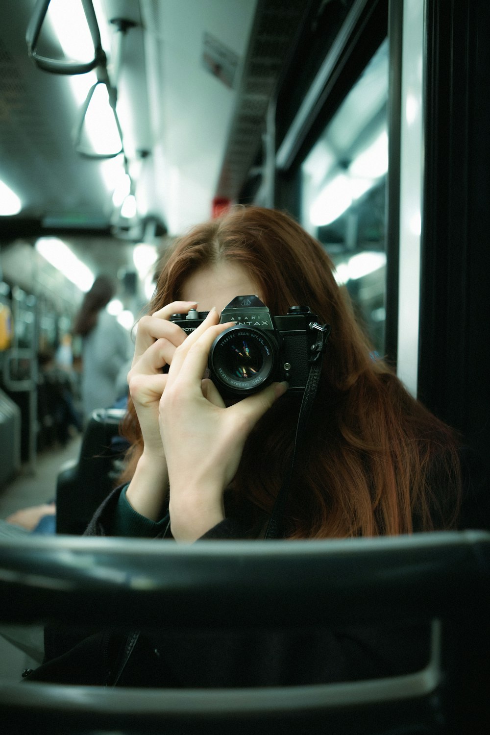 a woman taking a picture of herself with a camera