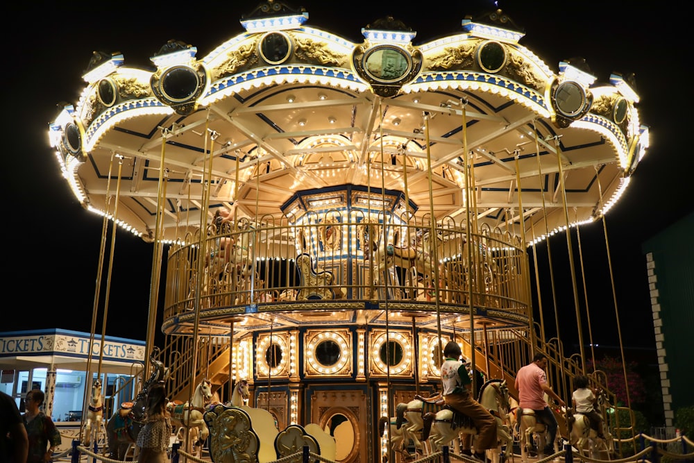 a merry go round at night with people on it