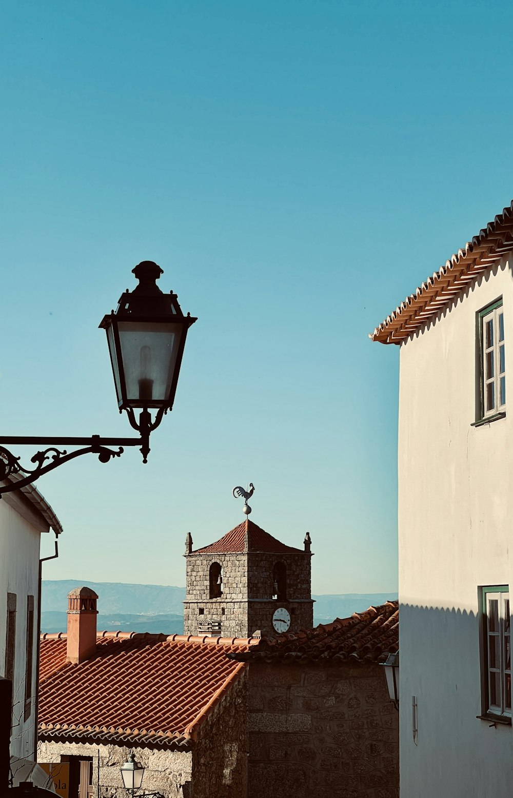 a street light hanging over a street next to a building