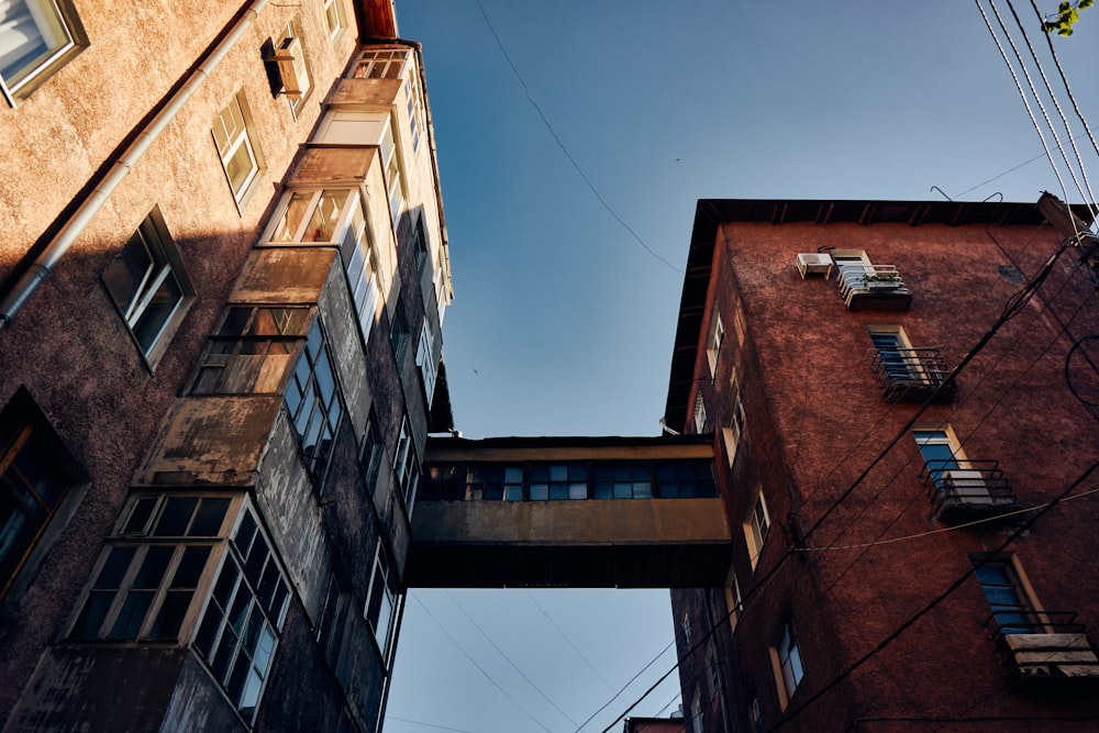 looking up at two tall buildings in a city