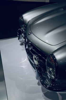 a shiny silver car on display in a museum