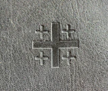 A minimalist cross etched onto a camouflage background, symbolizing faith in service.