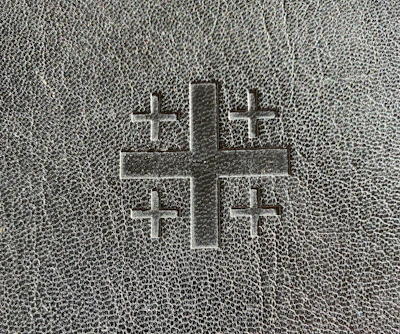 A minimalist cross etched onto a camouflage background, symbolizing faith in service.