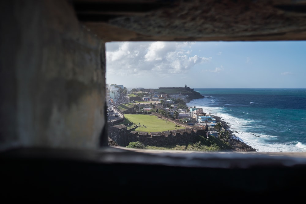 a view of the ocean from a window in a building