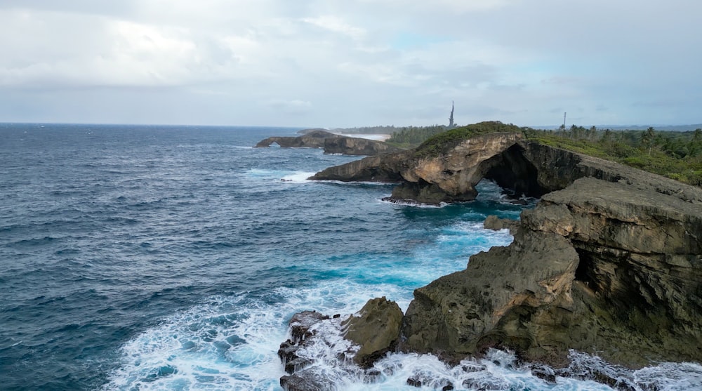 a large body of water next to a rocky shore