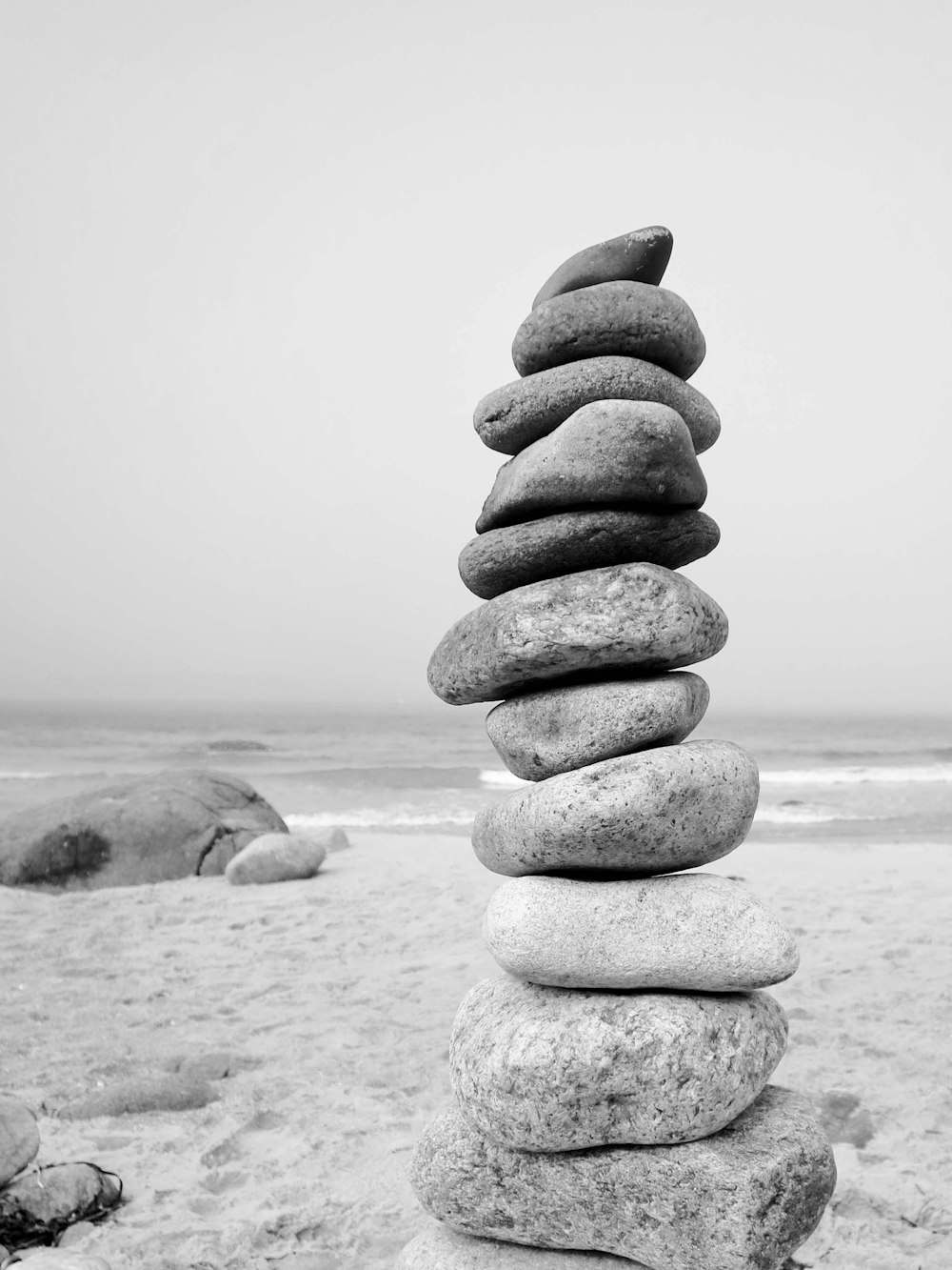 a stack of rocks sitting on top of a sandy beach