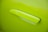 A close-up view of a vibrant lime green car door handle, seamlessly integrated into the door's surface.