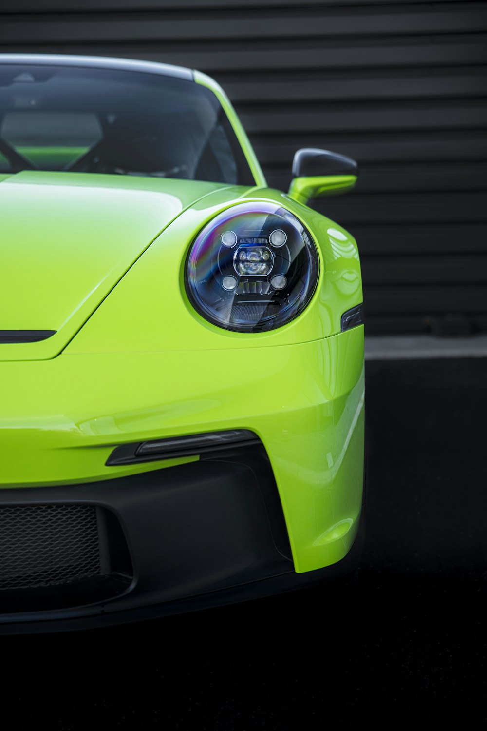 a close up of the front of a yellow sports car