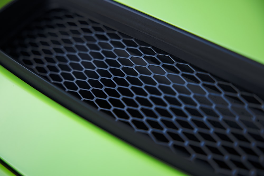 a close up of the grill on a green sports car