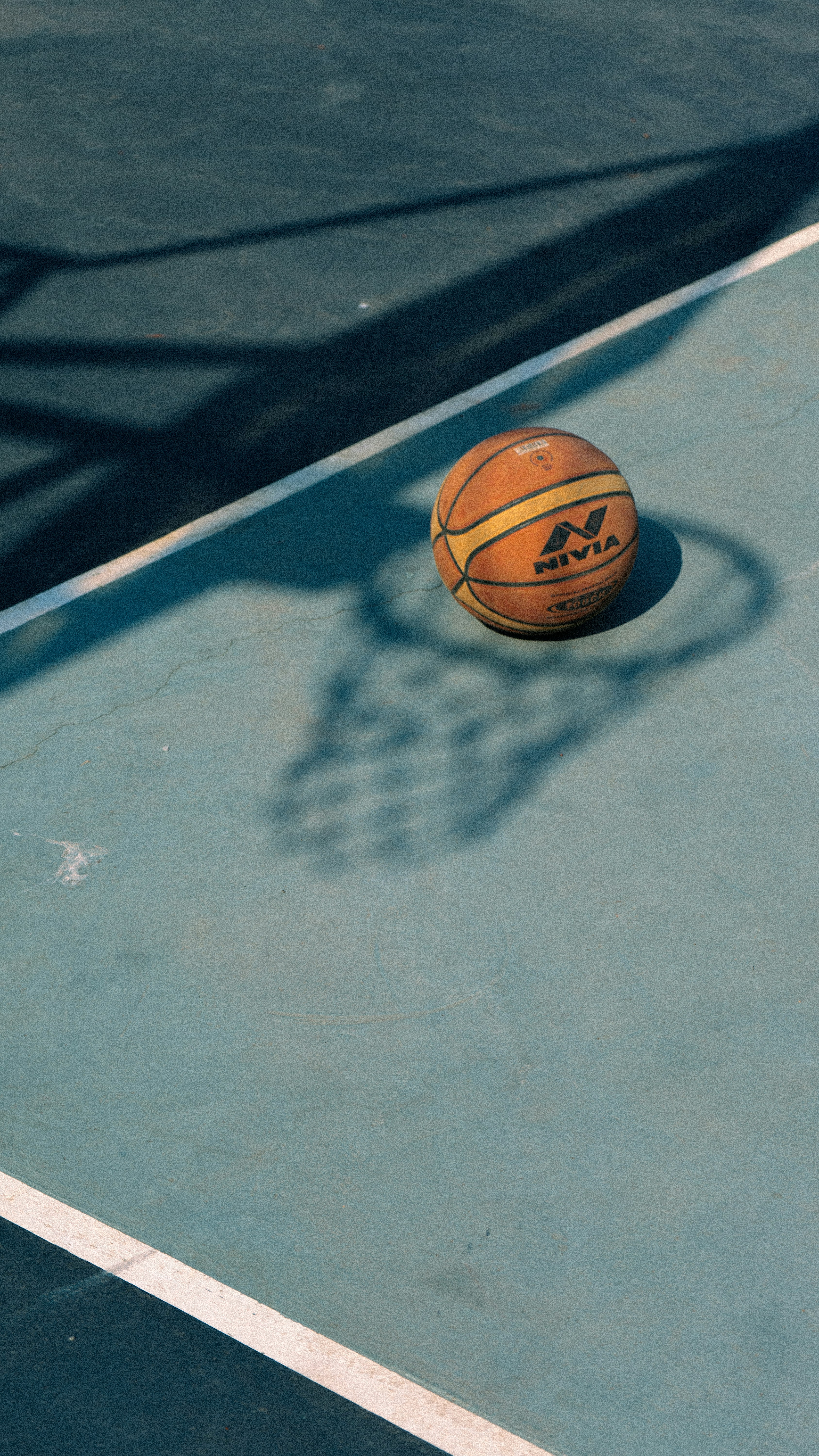 A basketball sitting on top of a basketball court photo Free Sphere
