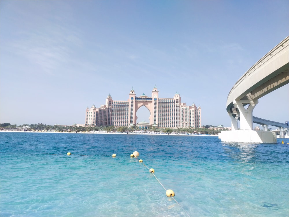 a body of water with a bridge in the background