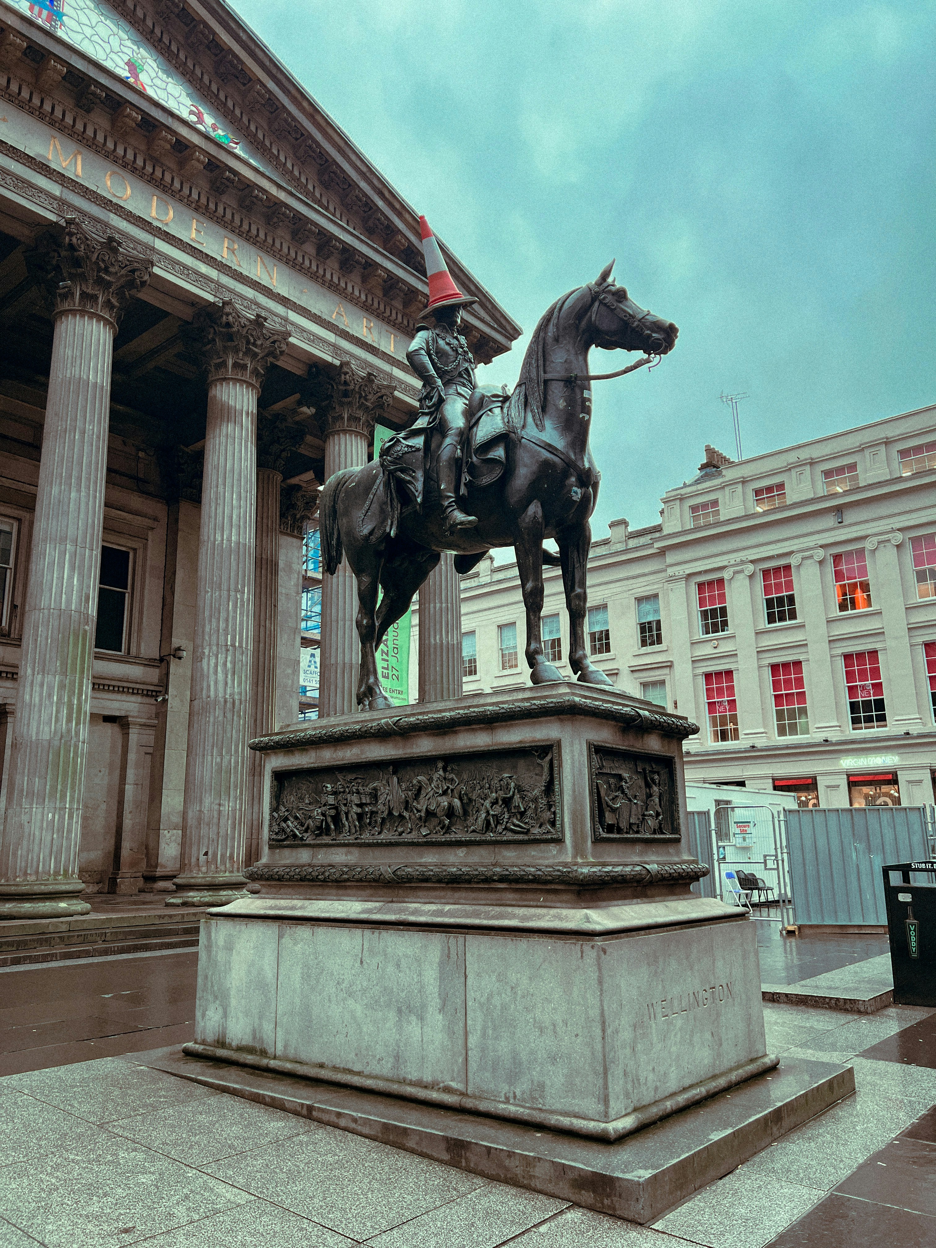 a statue of a man on a horse in front of a building