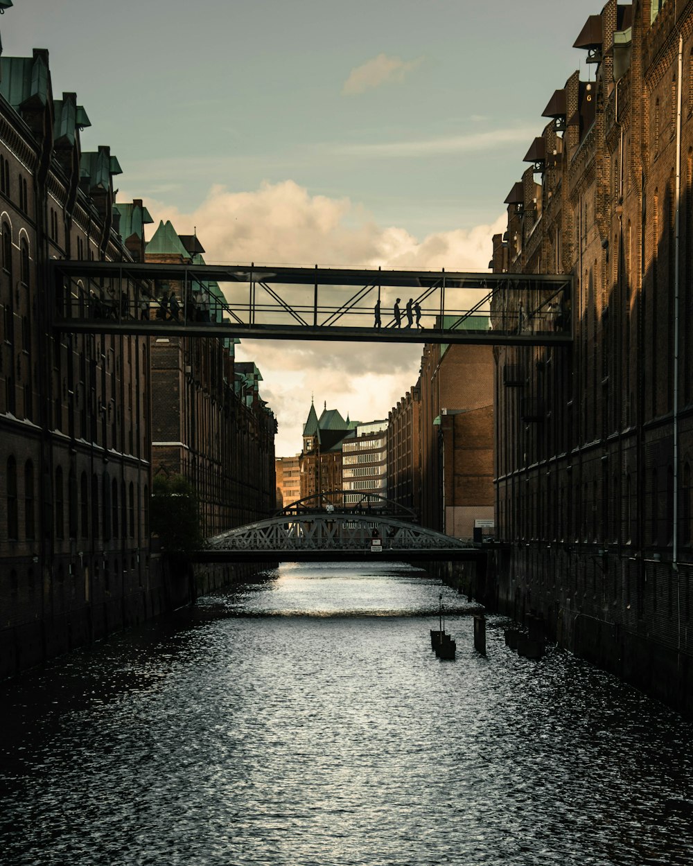 a bridge over a body of water next to tall buildings