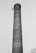 Close-up of technician inspecting chimney structure with flashlight