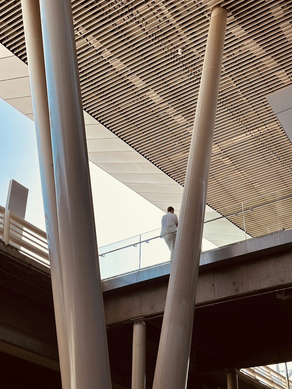 a man standing on a balcony next to a bridge