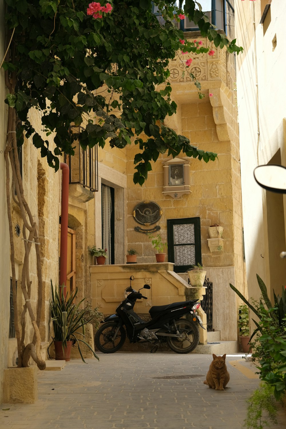 a motorcycle is parked in a narrow alley