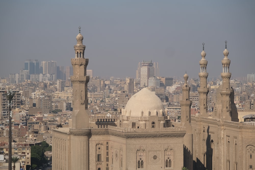 a view of a large building with a lot of tall buildings in the background