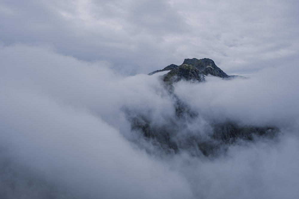 a view of a mountain covered in clouds