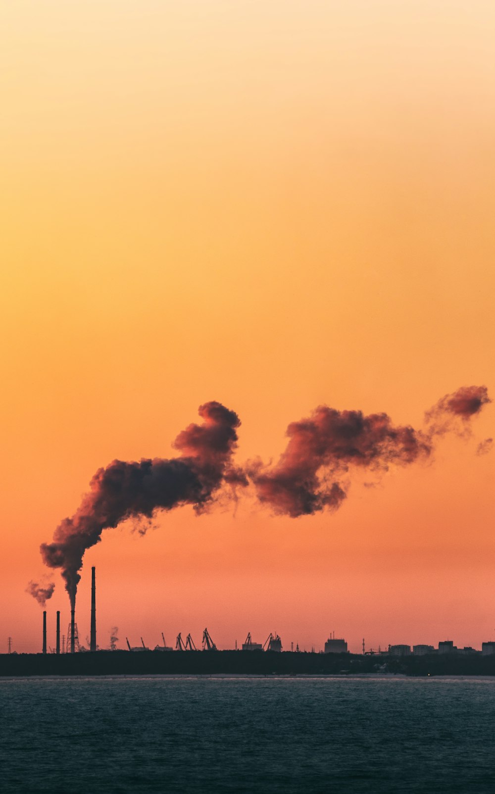 a factory with smoke coming out of it's stacks