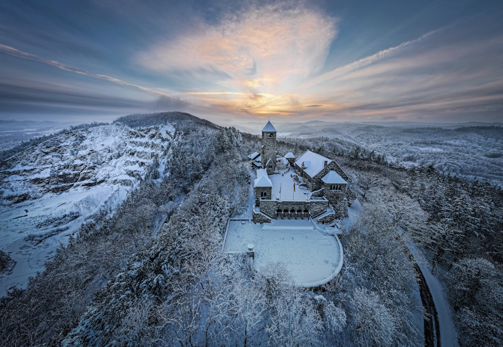 an aerial view of a house on a snowy hill