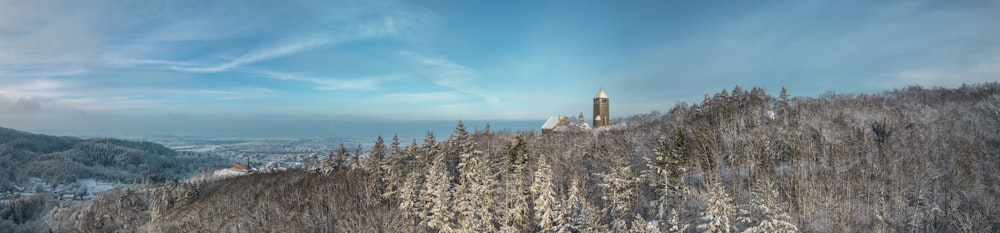 a snowy mountain with a clock tower in the distance