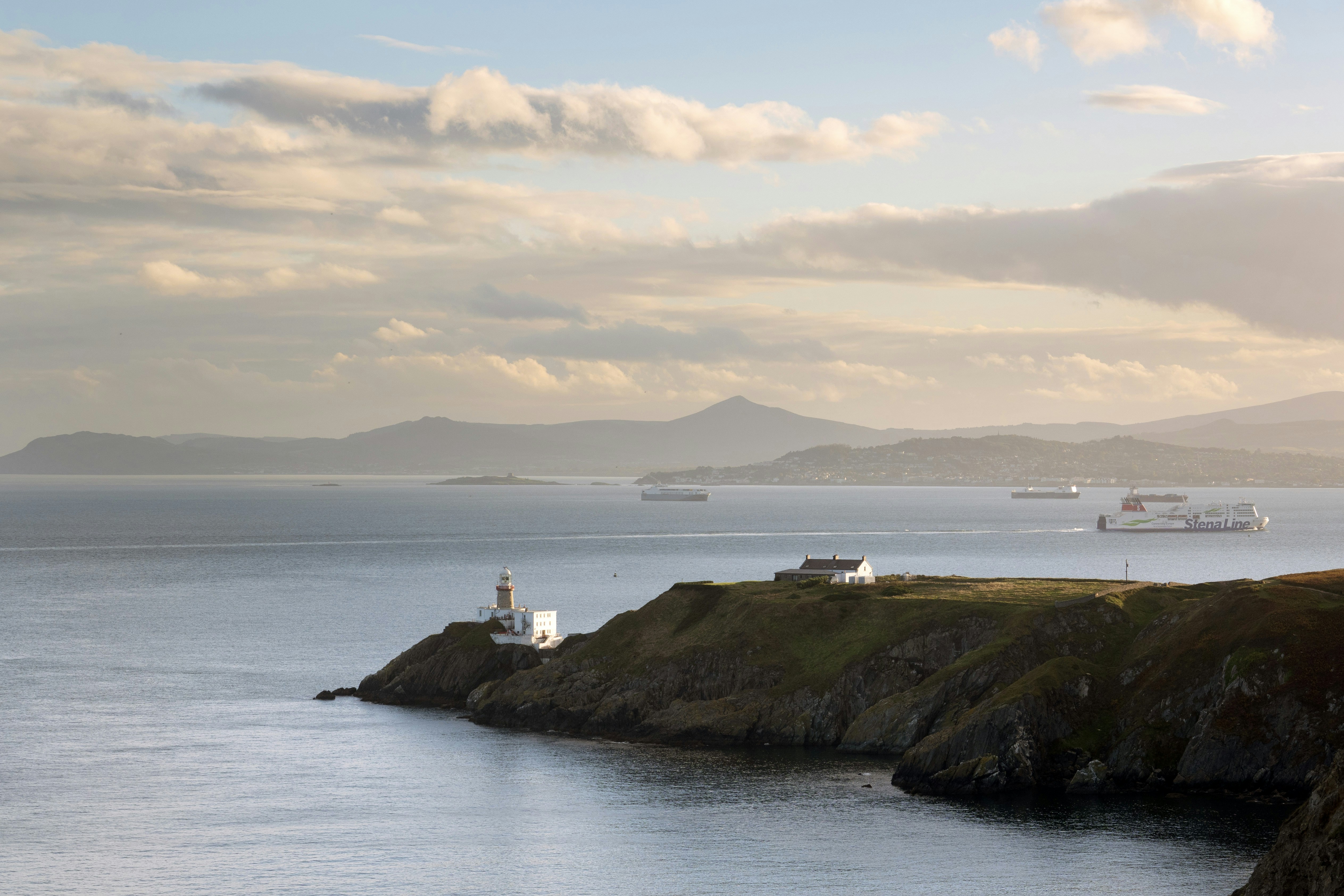 a lighthouse on a small island in the middle of the ocean