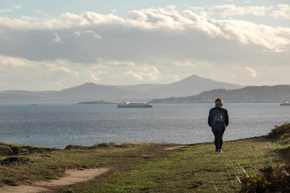 a person walking on a path near a body of water