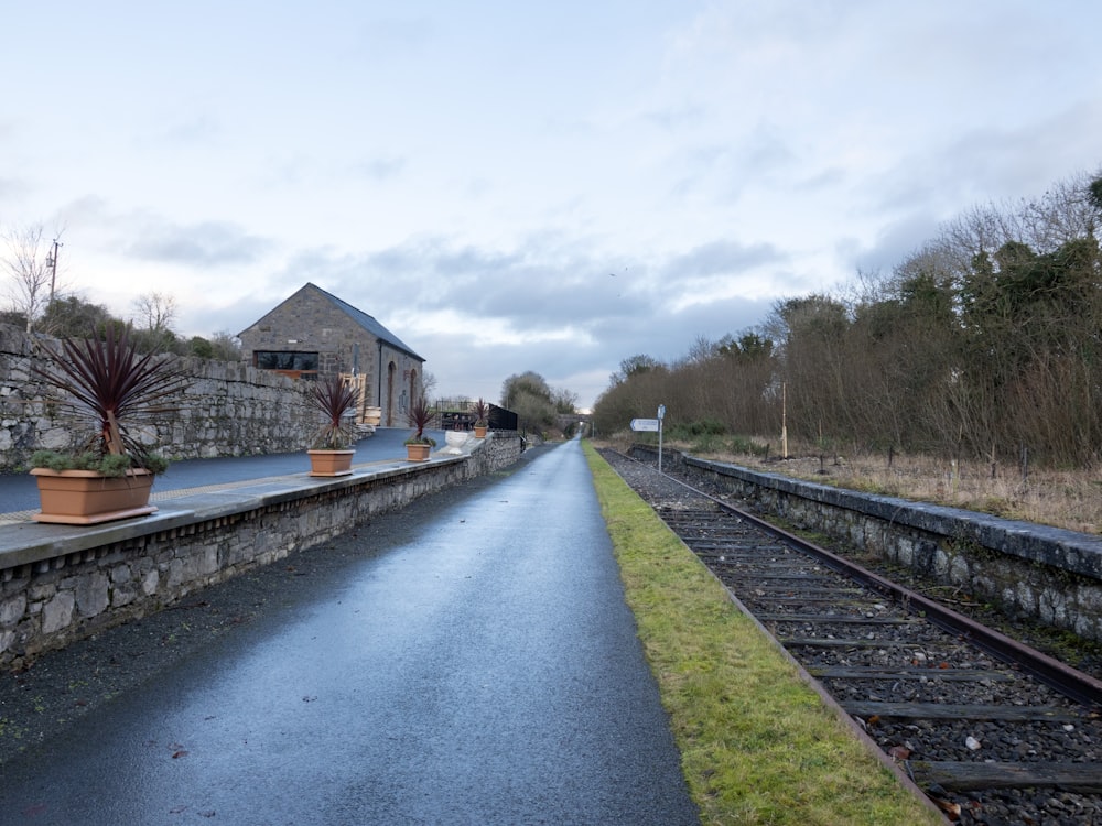 a train track next to a stone building