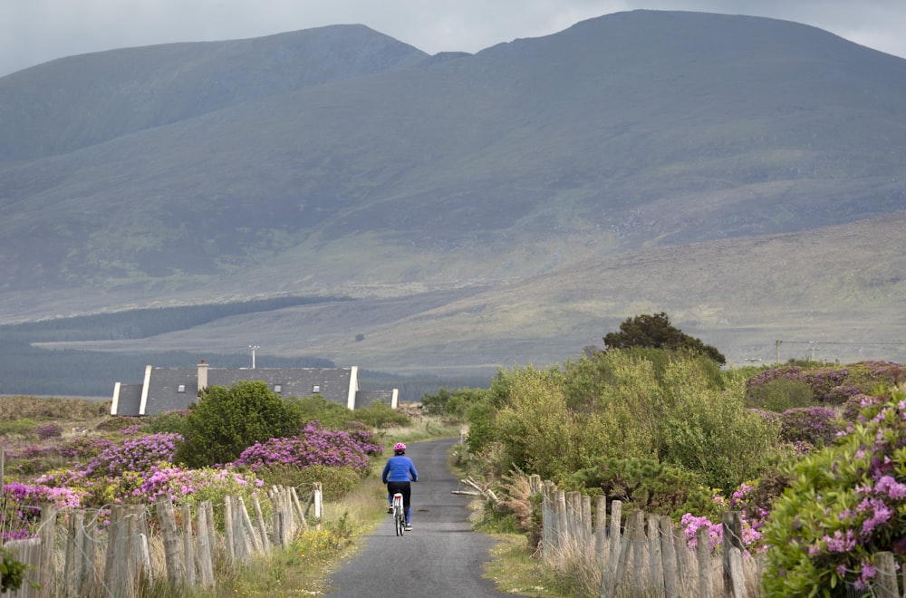 a person riding a bike down a road