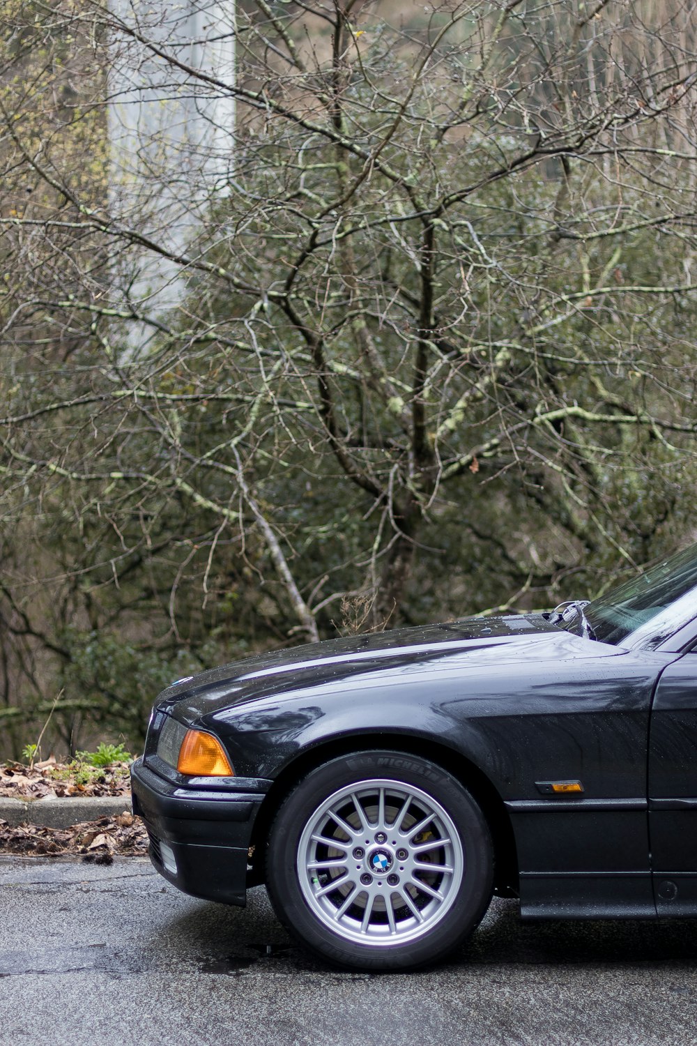 a black car parked on the side of the road