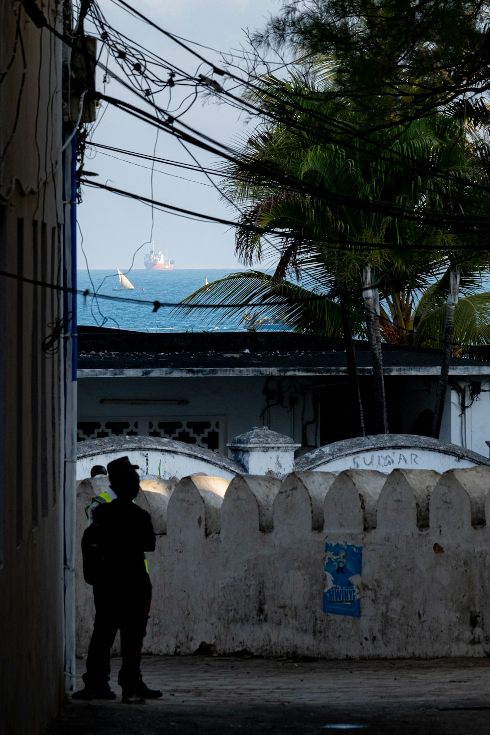 a police officer standing next to a white fence